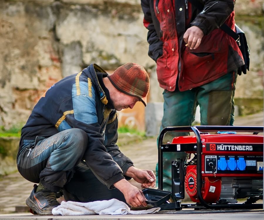 Technicians repairing a power generator